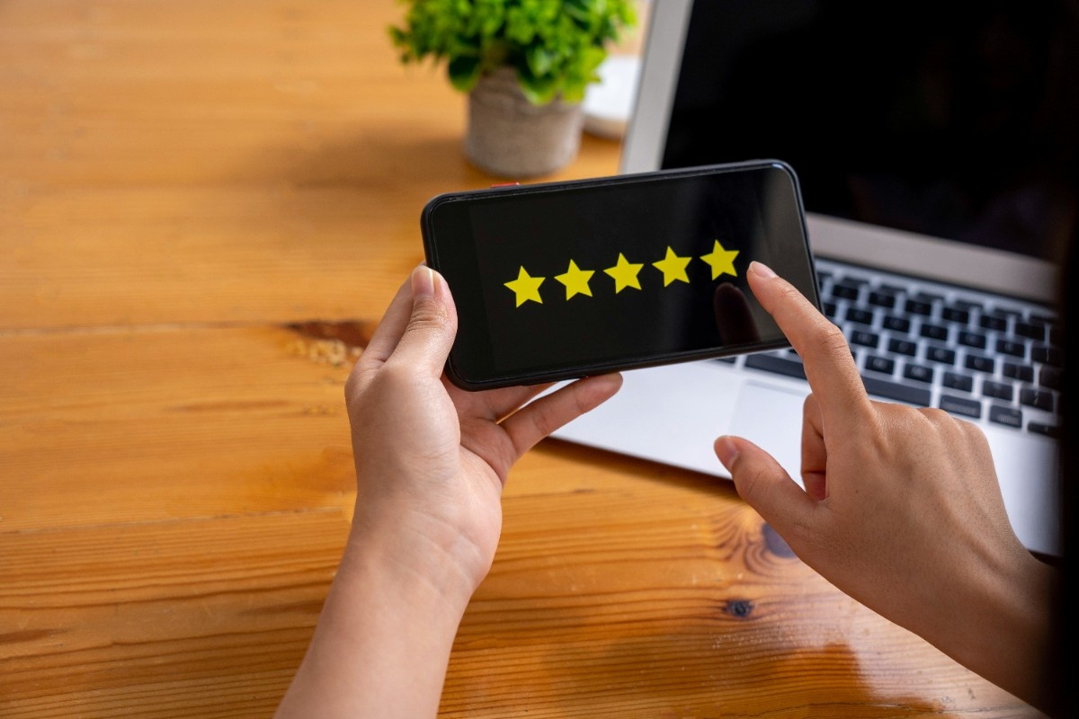 Five-star rating system with customer reviews and testimonials displayed on smartphone screen