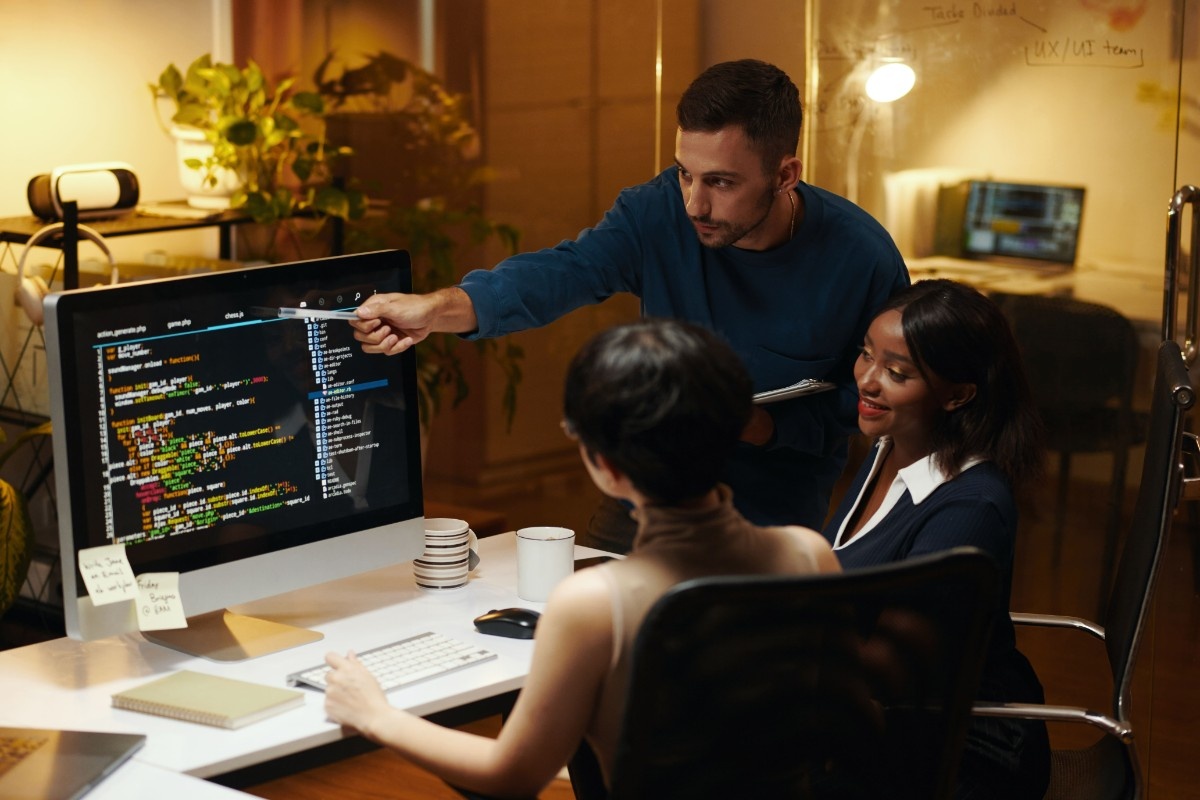 Computer screen displaying website code, HTML, CSS, and optimization programming